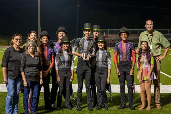 Ravenwood High band members march